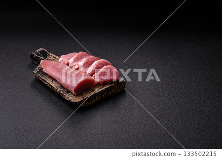 Raw pork tenderloin, sliced, is fresh meat, a source of protein. Pork tenderloin 133502215
