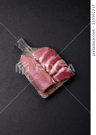 Raw pork tenderloin, sliced, is fresh meat, a source of protein. Pork tenderloin Raw pork tenderloin, sliced, is fresh meat, a source of protein. Pork tenderloin 133502217