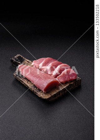 Raw pork tenderloin, sliced, is fresh meat, a source of protein. Pork tenderloin Raw pork tenderloin, sliced, is fresh meat, a source of protein. Pork tenderloin 133502218
