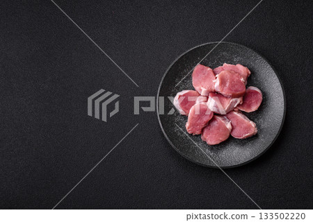 Raw pork tenderloin, sliced, is fresh meat, a source of protein. Pork tenderloin Raw pork tenderloin, sliced, is fresh meat, a source of protein. Pork tenderloin 133502220