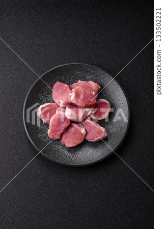 Raw pork tenderloin, sliced, is fresh meat, a source of protein. Pork tenderloin Raw pork tenderloin, sliced, is fresh meat, a source of protein. Pork tenderloin 133502221
