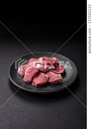 Raw pork tenderloin, sliced, is fresh meat, a source of protein. Pork tenderloin Raw pork tenderloin, sliced, is fresh meat, a source of protein. Pork tenderloin 133502222