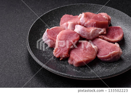 Raw pork tenderloin, sliced, is fresh meat, a source of protein. Pork tenderloin Raw pork tenderloin, sliced, is fresh meat, a source of protein. Pork tenderloin 133502223