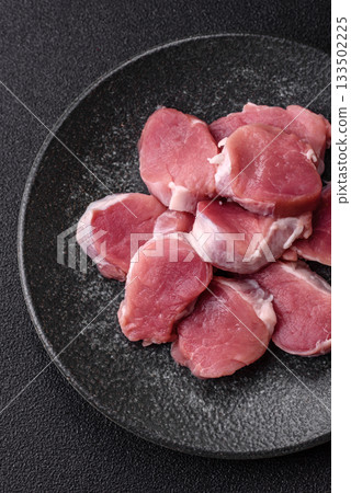 Raw pork tenderloin, sliced, is fresh meat, a source of protein. Pork tenderloin Raw pork tenderloin, sliced, is fresh meat, a source of protein. Pork tenderloin 133502225