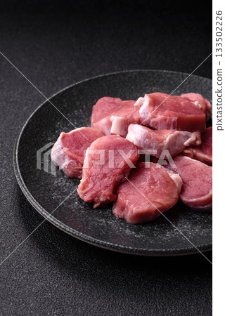 Raw pork tenderloin, sliced, is fresh meat, a source of protein. Pork tenderloin Raw pork tenderloin, sliced, is fresh meat, a source of protein. Pork tenderloin 133502226