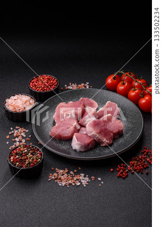 Raw pork tenderloin, sliced, is fresh meat, a source of protein. Pork tenderloin Raw pork tenderloin, sliced, is fresh meat, a source of protein. Pork tenderloin 133502234