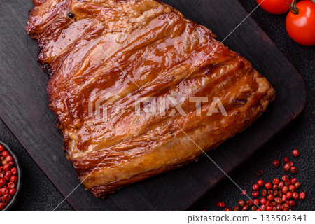 Grilled or barbecued pork or beef ribs with sauce. Cooked or smoked ribs 133502341