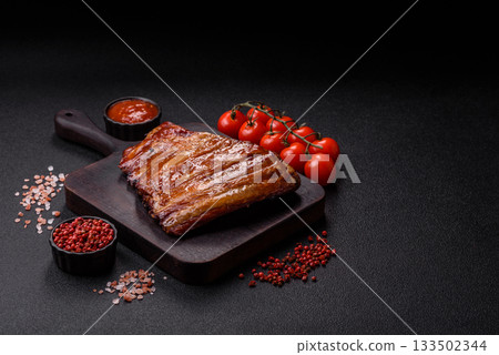 Grilled or barbecued pork or beef ribs with sauce. Cooked or smoked ribs Grilled or barbecued pork or beef ribs with sauce. Cooked or smoked ribs 133502344