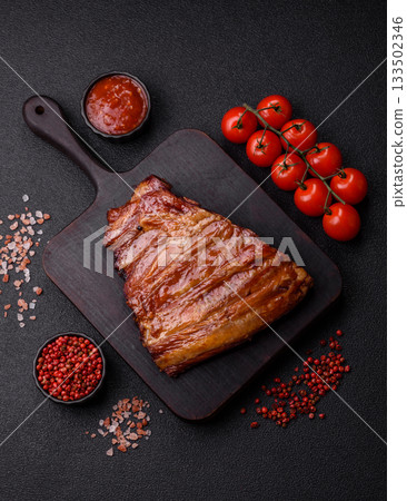 Grilled or barbecued pork or beef ribs with sauce. Cooked or smoked ribs Grilled or barbecued pork or beef ribs with sauce. Cooked or smoked ribs 133502346