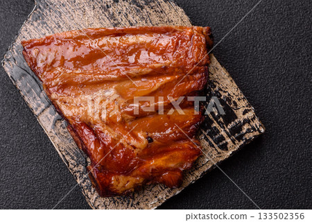 Grilled or barbecued pork or beef ribs with sauce. Cooked or smoked ribs Grilled or barbecued pork or beef ribs with sauce. Cooked or smoked ribs 133502356