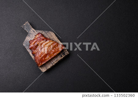 Grilled or barbecued pork or beef ribs with sauce. Cooked or smoked ribs 133502360