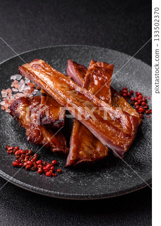 Grilled or barbecued pork or beef ribs with sauce. Cooked or smoked ribs Grilled or barbecued pork or beef ribs with sauce. Cooked or smoked ribs 133502370