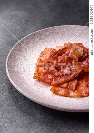 Fried pork bacon slices or strips as a breakfast ingredient. Fried bacon 133502445
