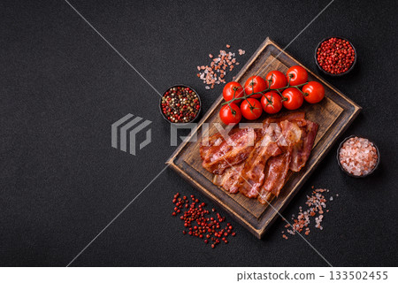 Fried pork bacon slices or strips as a breakfast ingredient. Fried bacon Fried pork bacon slices or strips as a breakfast ingredient. Fried bacon 133502455