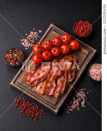 Fried pork bacon slices or strips as a breakfast ingredient. Fried bacon Fried pork bacon slices or strips as a breakfast ingredient. Fried bacon 133502456