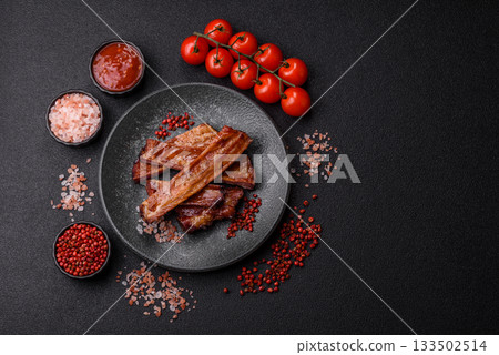 Grilled or barbecued pork or beef ribs with sauce. Cooked or smoked ribs Grilled or barbecued pork or beef ribs with sauce. Cooked or smoked ribs 133502514