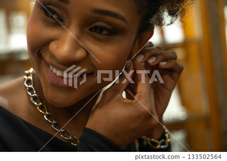 Woman getting earrings Woman getting earrings 133502564
