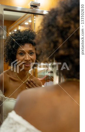 Woman with necklace in mirror Woman with necklace in mirror 133502630