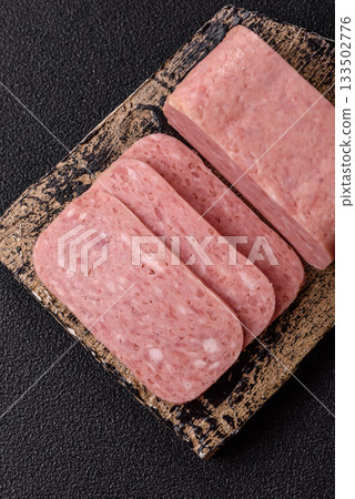 Spiced ham slices, canned meat for lunch sandwiches. Spiced ham as a food background 133502776