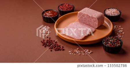Spiced ham slices, canned meat for lunch sandwiches. Spiced ham as a food background Spiced ham slices, canned meat for lunch sandwiches. Spiced ham as a food background 133502786