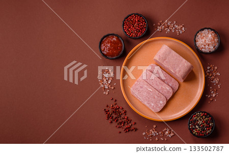 Spiced ham slices, canned meat for lunch sandwiches. Spiced ham as a food background 133502787