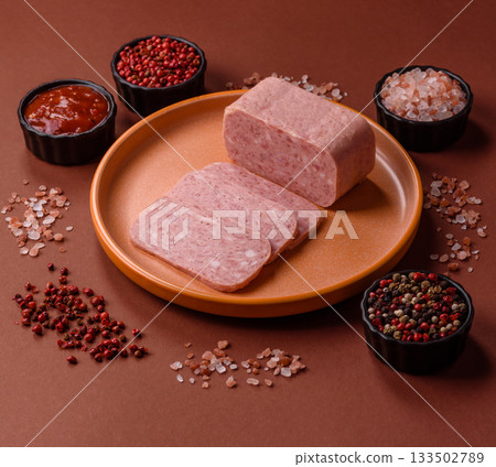 Spiced ham slices, canned meat for lunch sandwiches. Spiced ham as a food background 133502789