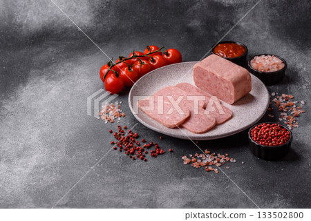 Spiced ham slices, canned meat for lunch sandwiches. Spiced ham as a food background 133502800