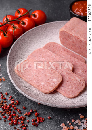 Spiced ham slices, canned meat for lunch sandwiches. Spiced ham as a food background Spiced ham slices, canned meat for lunch sandwiches. Spiced ham as a food background 133502806