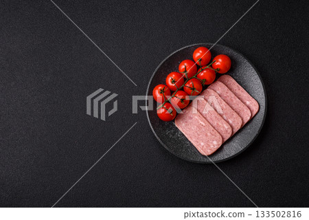 Spiced ham slices, canned meat for lunch sandwiches. Spiced ham as a food background Spiced ham slices, canned meat for lunch sandwiches. Spiced ham as a food background 133502816