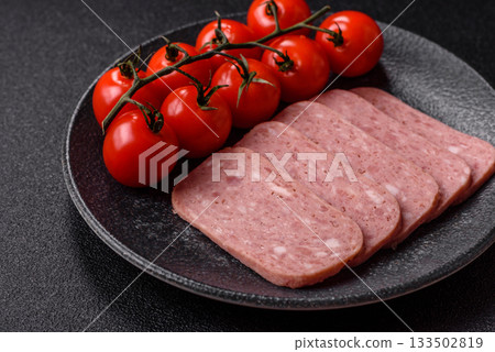 Spiced ham slices, canned meat for lunch sandwiches. Spiced ham as a food background 133502819