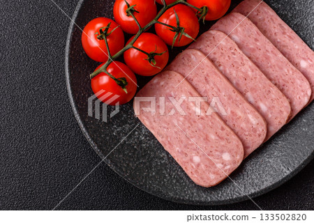 Spiced ham slices, canned meat for lunch sandwiches. Spiced ham as a food background 133502820