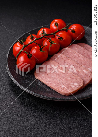 Spiced ham slices, canned meat for lunch sandwiches. Spiced ham as a food background 133502822