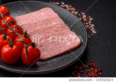 Spiced ham slices, canned meat for lunch sandwiches. Spiced ham as a food background 133502823