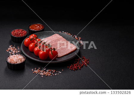 Spiced ham slices, canned meat for lunch sandwiches. Spiced ham as a food background 133502826