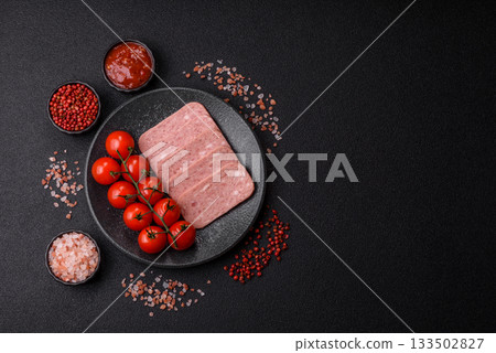 Spiced ham slices, canned meat for lunch sandwiches. Spiced ham as a food background 133502827