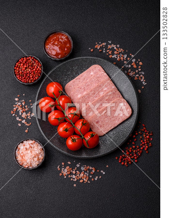 Spiced ham slices, canned meat for lunch sandwiches. Spiced ham as a food background 133502828