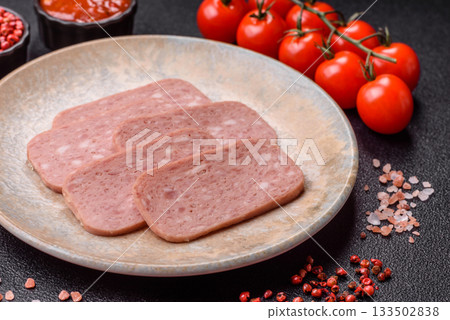 Spiced ham slices, canned meat for lunch sandwiches. Spiced ham as a food background 133502838