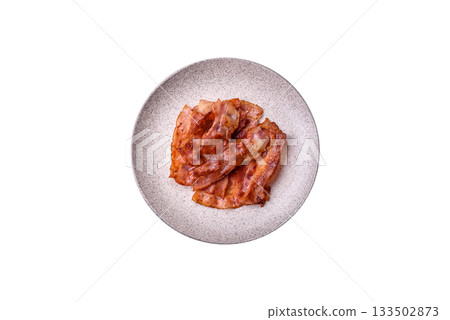 Fried pork bacon slices or strips as a breakfast ingredient. Fried bacon Fried pork bacon slices or strips as a breakfast ingredient. Fried bacon 133502873