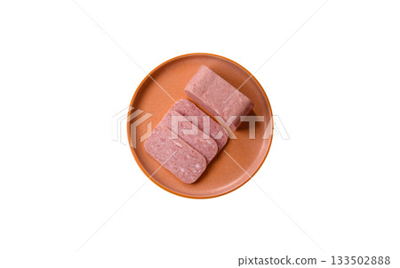 Spiced ham slices, canned meat for lunch sandwiches. Spiced ham as a food background 133502888