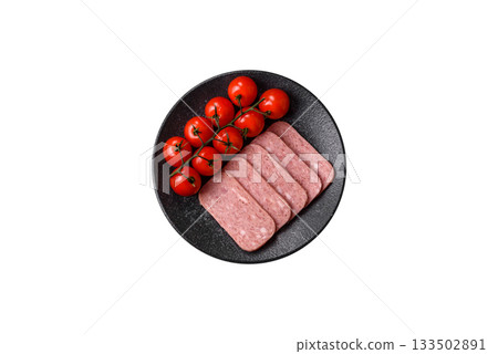 Spiced ham slices, canned meat for lunch sandwiches. Spiced ham as a food background Spiced ham slices, canned meat for lunch sandwiches. Spiced ham as a food background 133502891