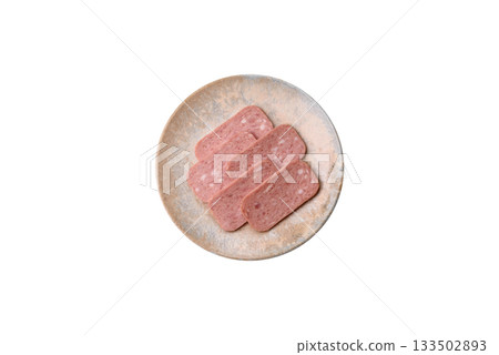 Spiced ham slices, canned meat for lunch sandwiches. Spiced ham as a food background Spiced ham slices, canned meat for lunch sandwiches. Spiced ham as a food background 133502893
