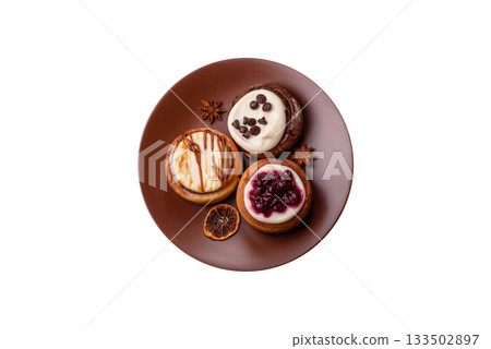 Cinnamon roll, a sweet bun with citrus, cherries, and chocolate, a Danish dessert with cream 133502897