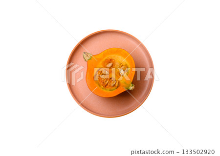 Half a raw pumpkin, a ripe orange colored butternut squash. Raw pumpkin Half a raw pumpkin, a ripe orange colored butternut squash. Raw pumpkin 133502920