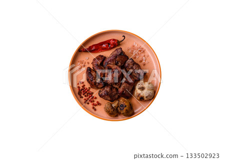 Beef, grilled meat in pieces, or kebab with sauce and vegetables. Beef in pieces Beef, grilled meat in pieces, or kebab with sauce and vegetables. Beef in pieces 133502923