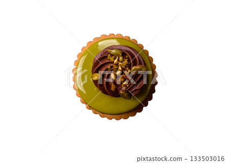 Pistachio cake or tart topped with green mousse with nuts and fruit filling. Pistachio pie 133503016