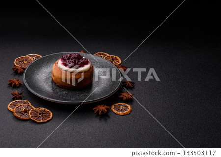 Cinnamon roll, a sweet bun with citrus, cherries, and chocolate, a Danish dessert with cream 133503117