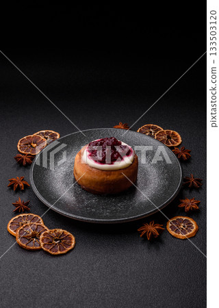 Cinnamon roll, a sweet bun with citrus, cherries, and chocolate, a Danish dessert with cream Cinnamon roll, a sweet bun with citrus, cherries, and chocolate, a Danish dessert with cream 133503120