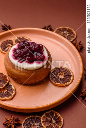 Cinnamon roll, a sweet bun with citrus, cherries, and chocolate, a Danish dessert with cream Cinnamon roll, a sweet bun with citrus, cherries, and chocolate, a Danish dessert with cream 133503131