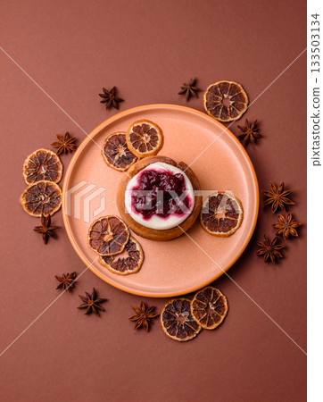 Cinnamon roll, a sweet bun with citrus, cherries, and chocolate, a Danish dessert with cream 133503134