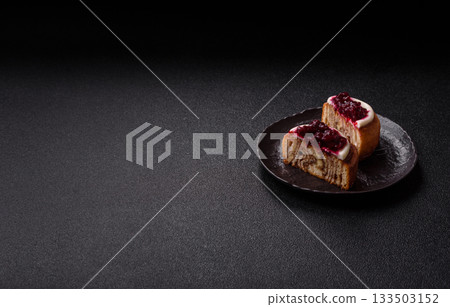 Cinnamon roll, a sweet bun with citrus, cherries, and chocolate, a Danish dessert with cream Cinnamon roll, a sweet bun with citrus, cherries, and chocolate, a Danish dessert with cream 133503152